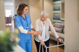 Older adult and family member review a care plan with staff in an assisted living common room.